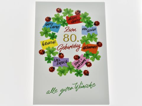 Geburtstagskarte mit dem Schriftzug Zum 80. Geburtstag, umgeben von Glücksklee und Marienkäfern. Bunte Aufkleber mit Wünschen wie Glück, Gesundheit und Erfolg. Hersteller: Juwelier Harnisch. Geburtstagskarten.