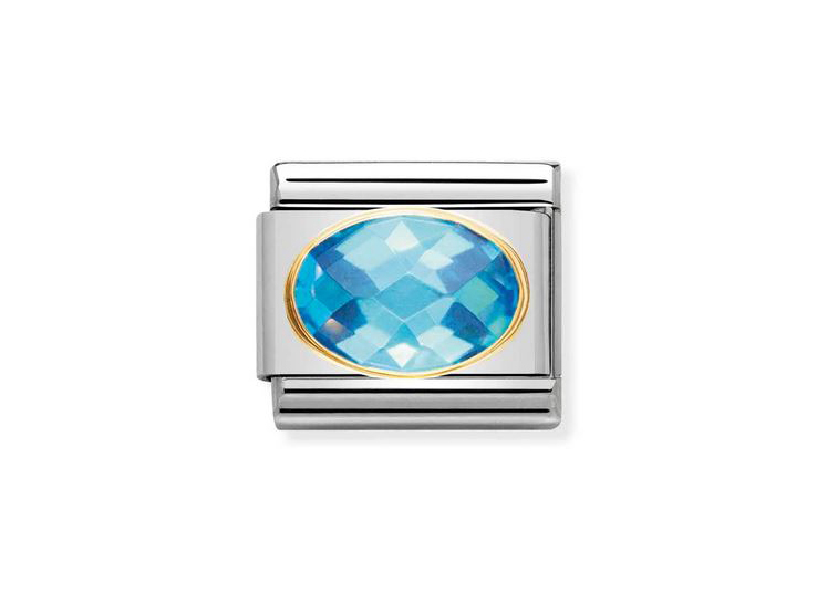 Zirkonia FACE Himmelblau von Nomination, ovaler Stein in intensiven Himmelblau-Tönen, umfasst von einem goldenen Rand und einem silbernen Gehäuse, ideal für Schmuckliebhaber.