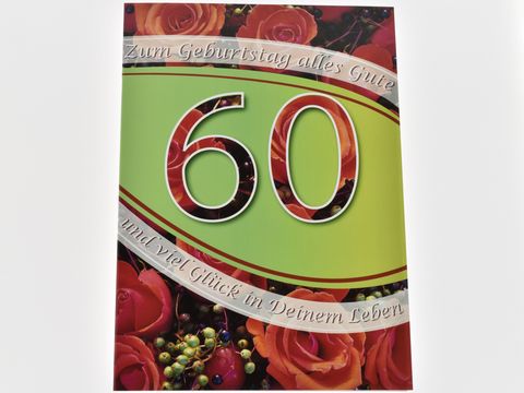 Geburtstagskarte mit der Zahl 60, umgeben von bunten Rosen und festlicher Dekoration, verziert mit dem Text zum Geburtstag alles Gute und viel Glück in deinem Leben. Hersteller: Juwelier Harnisch.