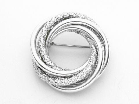 Brosche im Sexy City Look in poliertem und mattem Design, hergestellt von Juwelier Harnisch. Modischer Modeschmuck mit funkelnden Elementen, ideal für stilvolle Akzente.