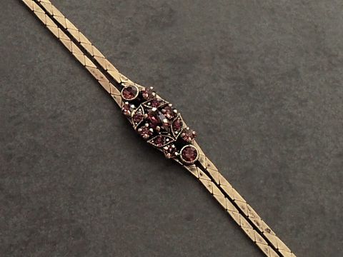 Stilvolles Strass Armband in lila mit goldfarbenem Design, Hersteller Juwelier Harnisch, geeignet für Handgelenke von 19 bis 21 cm, ideal für elegante Anlässe.