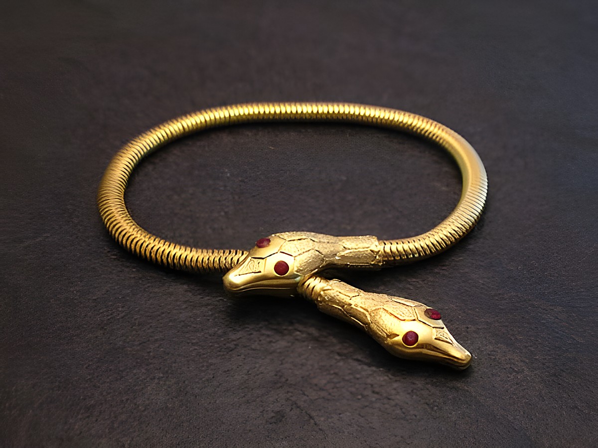 Schlangen Y Armband gut vergoldet 17 cm -City- Pink- von Juwelier Harnisch, mit dekorativen Schlangenköpfen und roten Steinakzenten, elegant und stilvoll für besondere Anlässe.