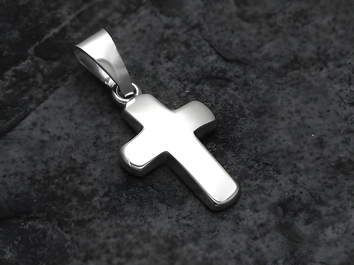 Anhänger aus Sterling Silber in Form eines kleinen, polierten Kreuzes, hergestellt von Juwelier Harnisch, schlichtes Design auf dunklem Hintergrund.