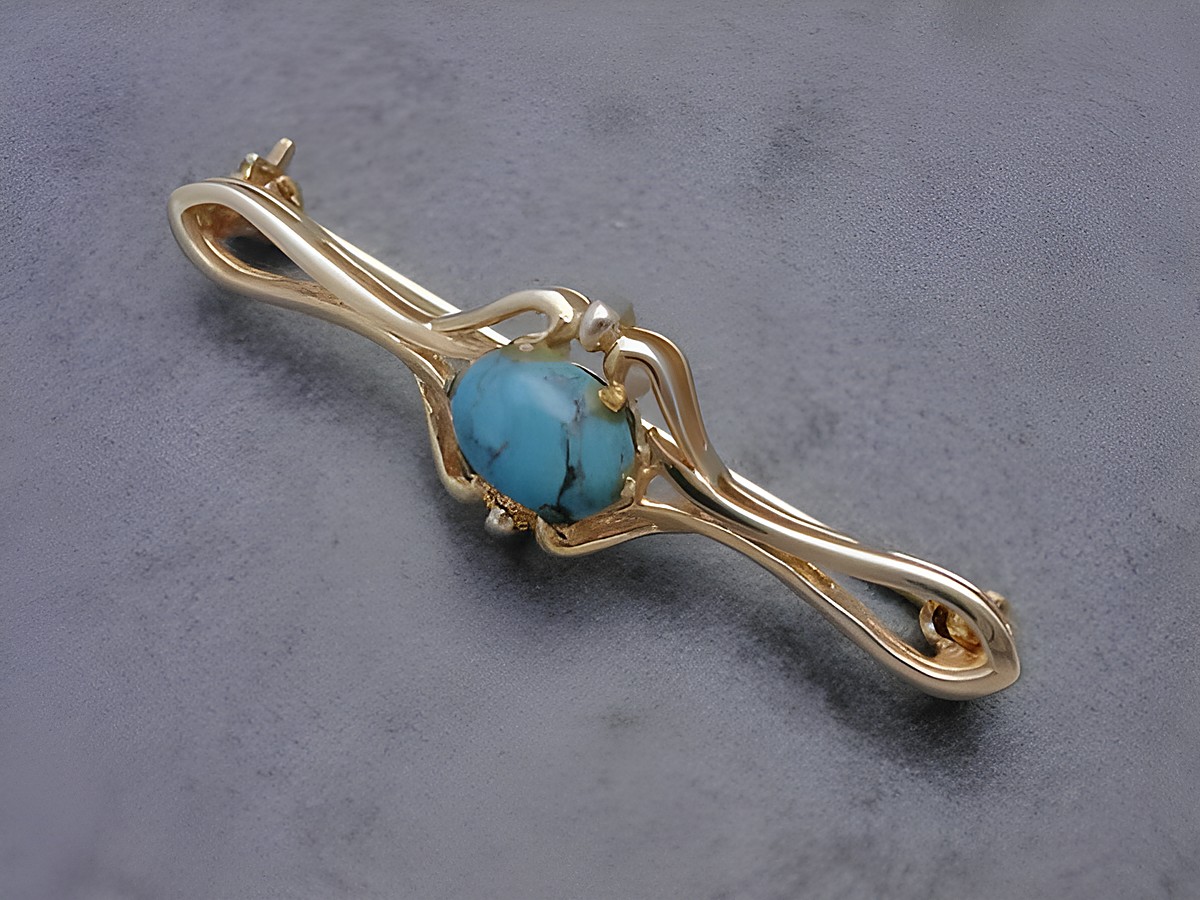 Gold auf Silber Brosche mit elegantem Design, verziert mit einem Türkis, hergestellt von Juwelier Harnisch, ideal zum ergänzen jedes Outfits.