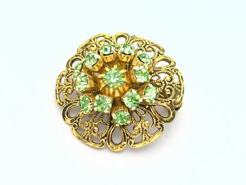 Damen Brosche im Sexy City Look Grün rund, Hersteller Juwelier Harnisch, Strass Brosche mit goldfarbenem Grund und glitzernden grünen Steinen, ideal für elegante Akzente.