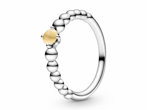 Pandora Silber Metallperlen Ring mit Topaz in gelb Größe 50, elegant gestalteter Ring mit runden Metallperlen und einem strahlenden gelben Stein im Zentrum.
