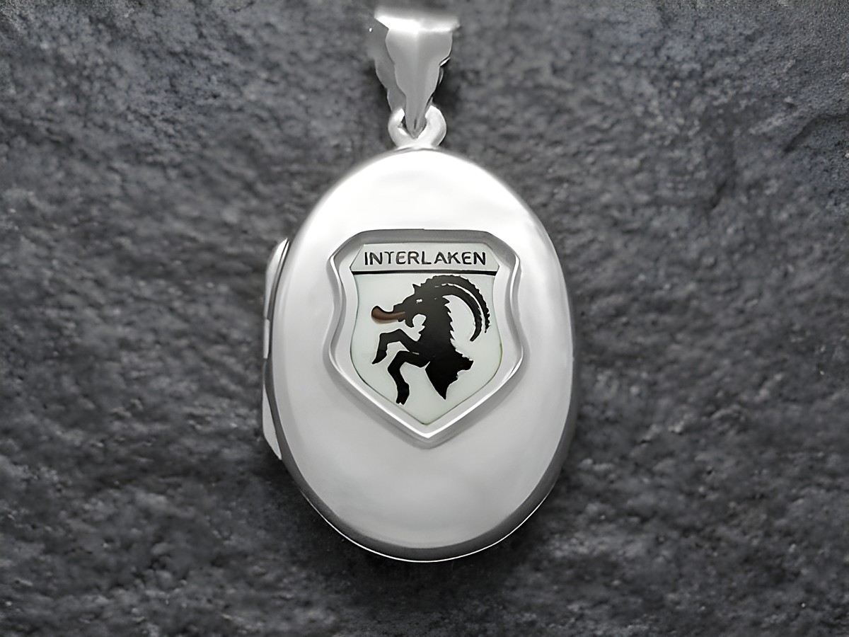 Silberne Medaille mit dem Stadtwappen von Interlaken, Schweiz. Das Wappen zeigt einen schwarzen Steinbock auf hellem Hintergrund. Hersteller ist Juwelier Harnisch, Europa Medaillons.