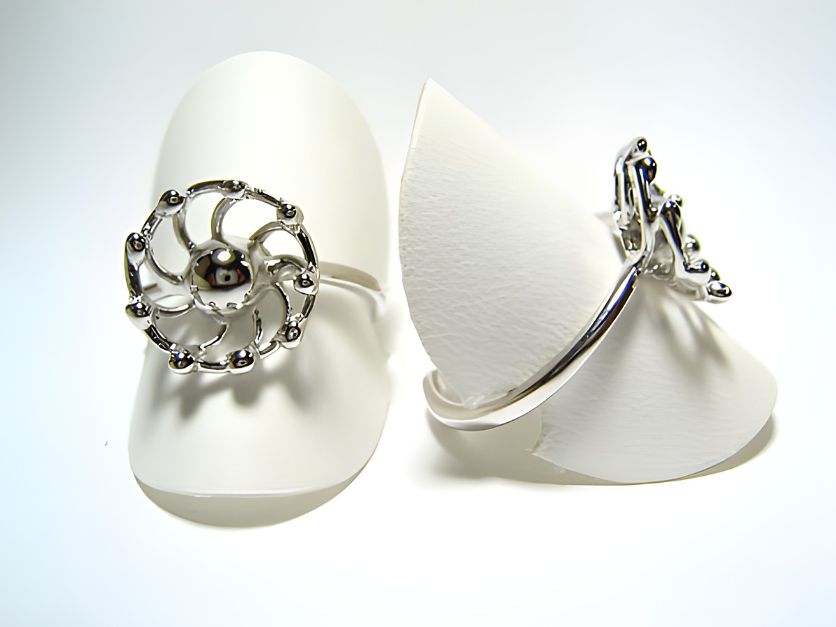 Silber Ring rhodiniert rundlich Gr. verstellbar Hersteller Juwelier Harnisch ohne Stein elegant und filigran auf einem weißen Präsentationsstütz.