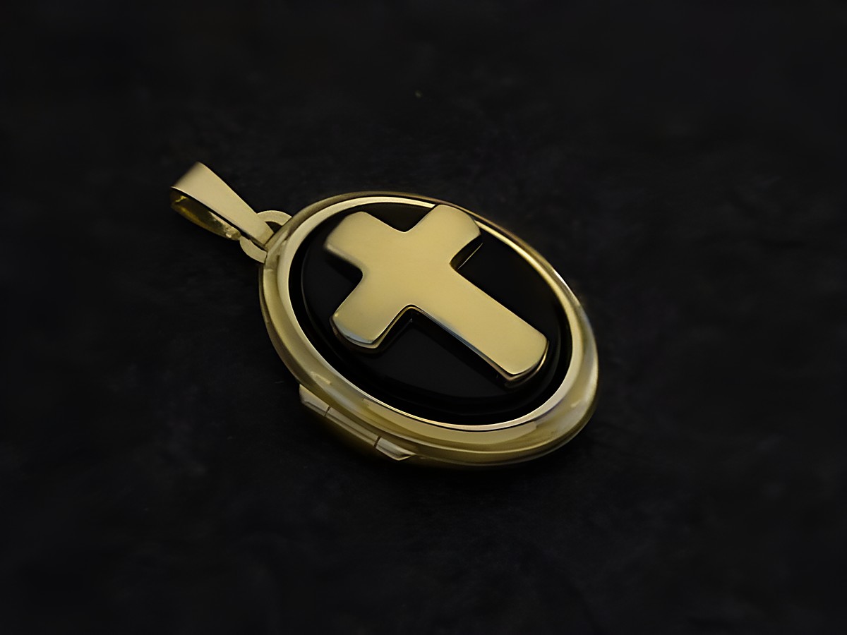 Kreuz Onyx und Gold Motiv Medaillon mit Cabochon aus Gold 750, Hersteller Juwelier Harnisch, elegantes Schmuckstück mit geschwärztem Hintergrund und goldenem Kreuz.