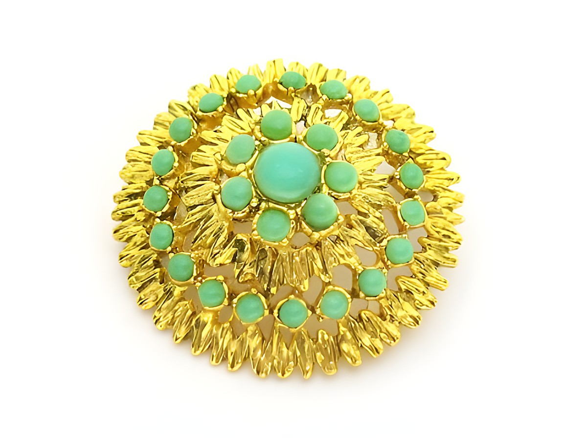 Brosche im Sexy City Look in smaragdgrün und goldfarben, rund gestaltet mit zahlreichen kleinen türkisen Steinen, hergestellt von Juwelier Harnisch, ideal für elegante Outfits.
