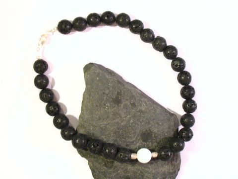 Schwarze Lava-Perlenkette mit einem Opal-Kascholong-Element, goldfarbener Zwischenperle und versilbertem Verschluss, Länge 45 cm, Hersteller Juwelier Harnisch, Lava Schmuck.
