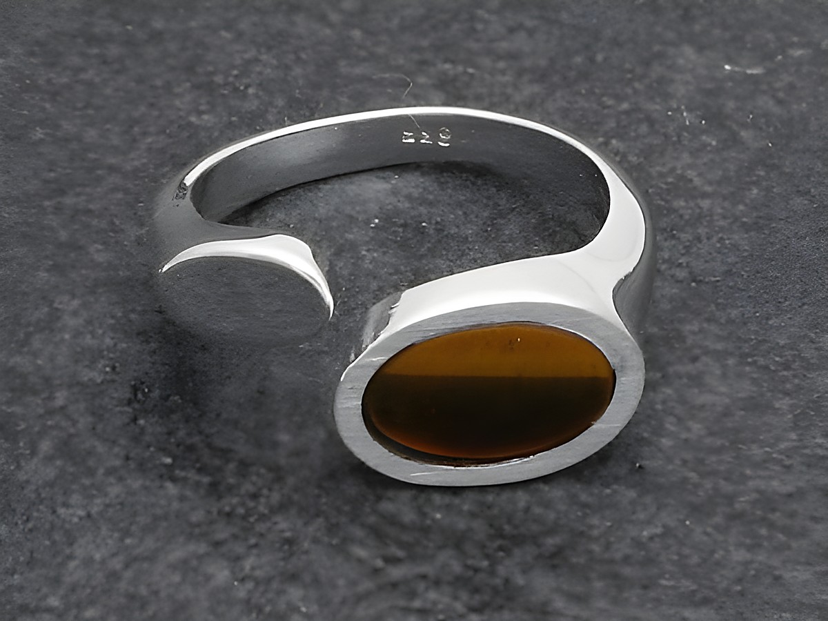 Futuristischer Silberring mit verstellbarem Design, eingefasstem Tigerauge und rhodiniertem Stein, hergestellt von Juwelier Harnisch. Elegant und modern, ideal für stilbewusste Träger.