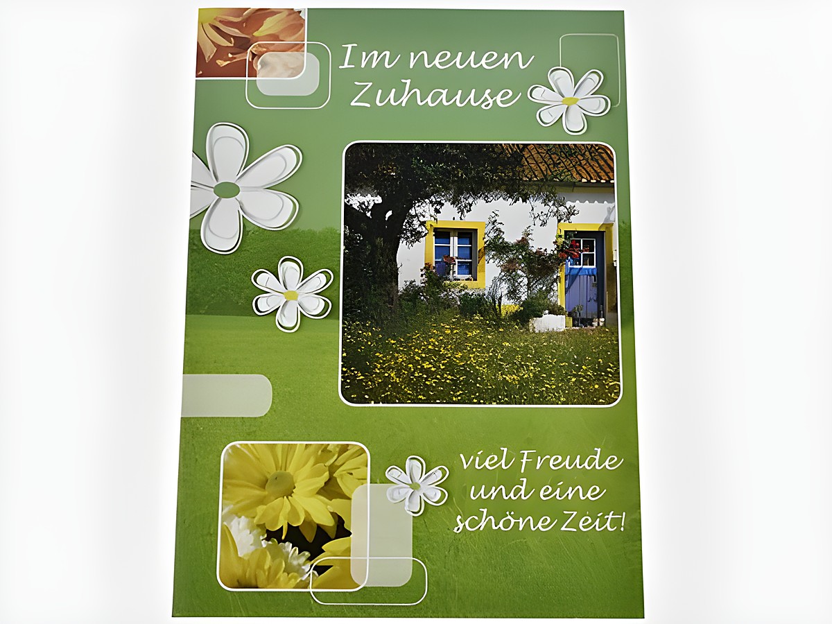 Eine Grußkarte mit dem Text Im neuen Zuhause, geschmückt mit Blumen, einer idyllischen Hausansicht und einem verdeckten Baum, ideal für Glückwünsche von Juwelier Harnisch.