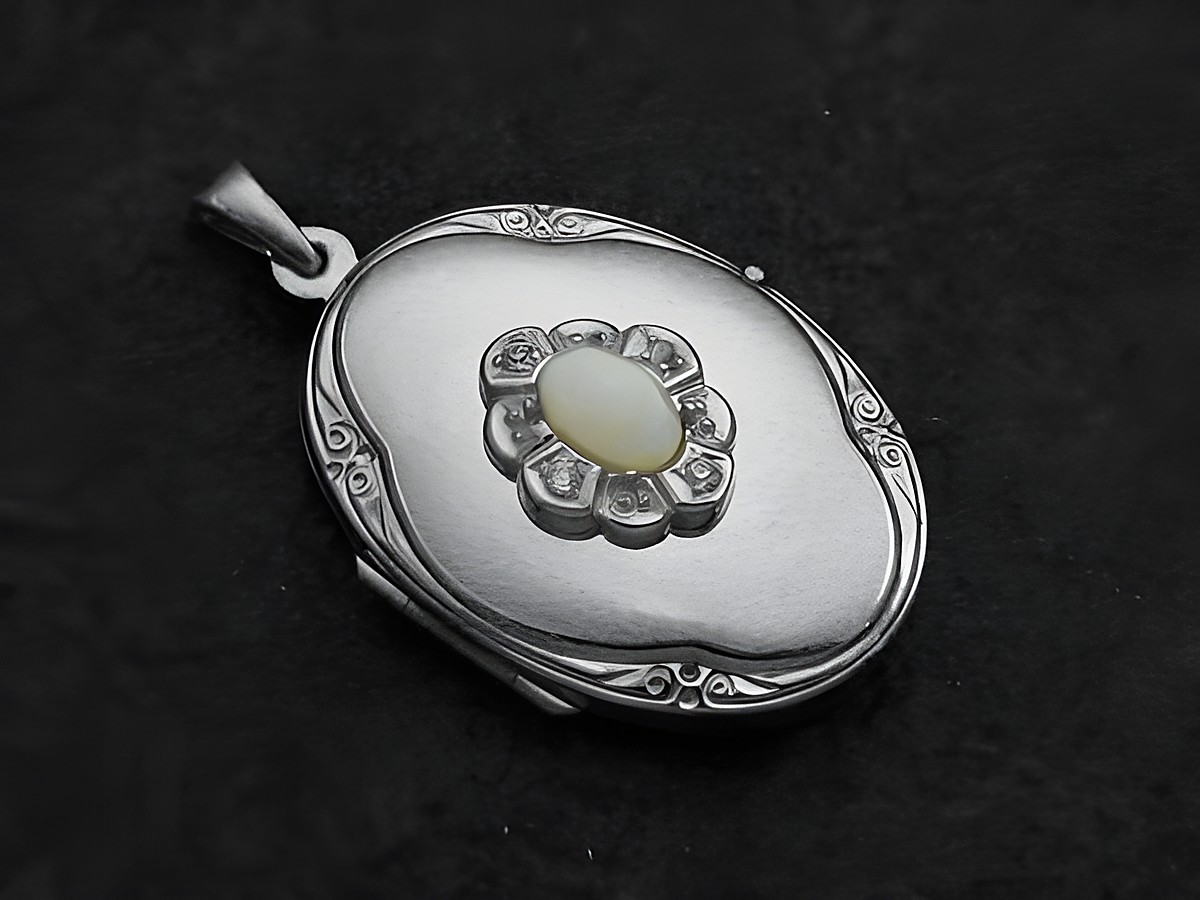 Opal weiß Medaillon Cabochon in Weißgold 585, gefertigt von Juwelier Harnisch, ovaler Anhänger mit filigraner Blumendekoration und einem leuchtenden Opal in der Mitte.