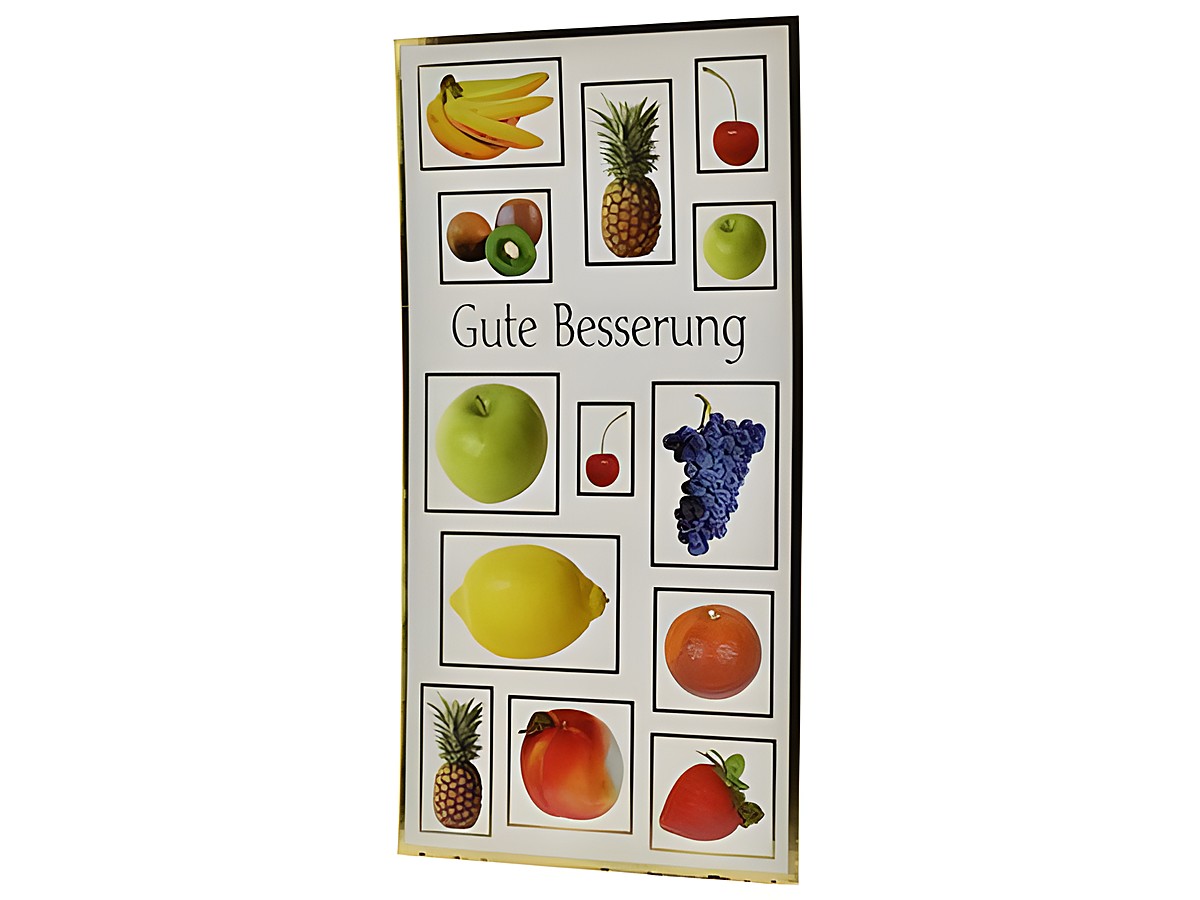 Eine Genesungskarte von Juwelier Harnisch mit verschiedenen Früchten, darunter Bananen, Äpfel, Ananas, Trauben, Zitrone und Pfirsich, mit dem Text Gute Besserung.