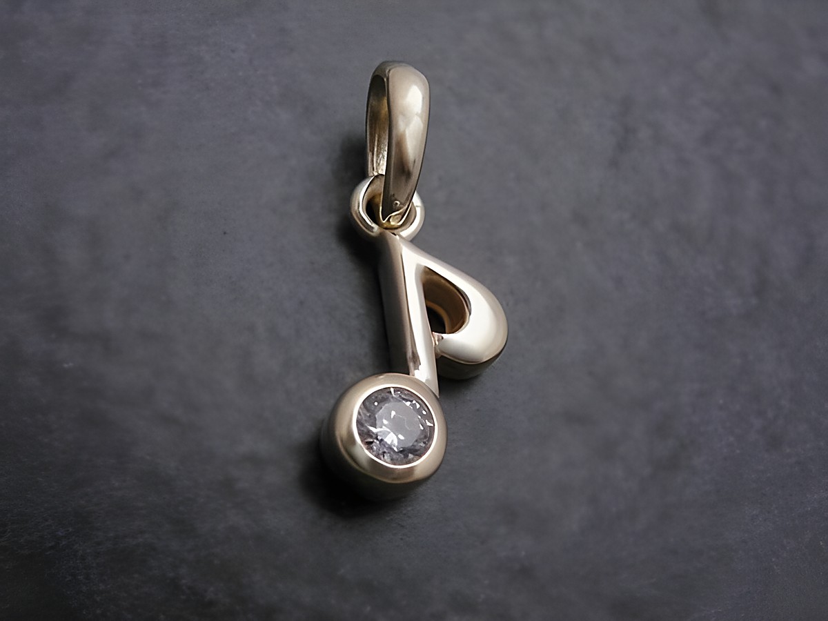 Gold Anhänger in Form einer Note für Musikfans, mit weißem Zirkonia, Hersteller: Juwelier Harnisch, ideal als Schmuckstück für Liebhaber der Musik.