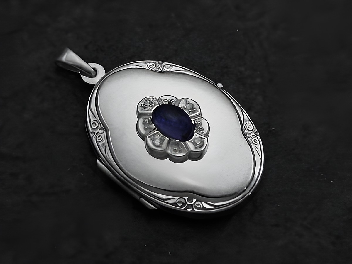 Iolite blau Medaillon Cabochon aus Weißgold 333 mit Brillanten, Hersteller Juwelier Harnisch, filigranes Design mit ovaler Form und floraler Verzierung.
