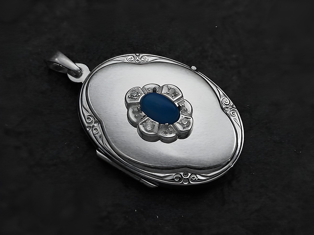 Achat blau Medaillon Cabochon in Weißgold 585 von Juwelier Harnisch, ovaler Anhänger mit blauer Steinmitte und umlaufender Ziersteineinfassung, elegantes Schmuckstück.