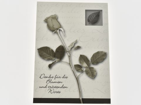 Dankeskarte mit einem dezenten Design, auf dem eine stilisierte Rose und ein Blatt abgebildet sind. Der Text bedankt sich für Blumen und tröstende Worte, Hersteller Juwelier Harnisch.
