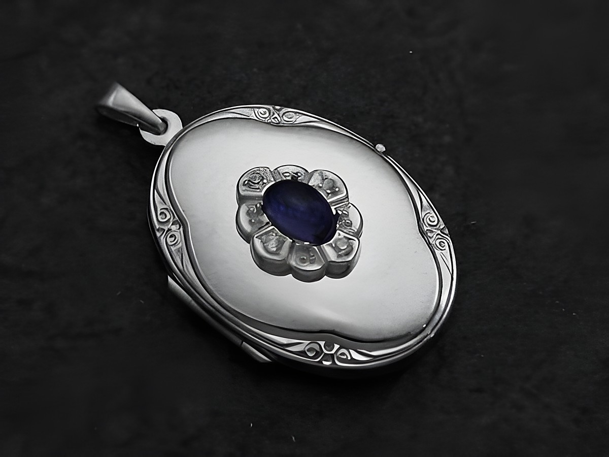 Iolite blau Medaillon Cabochon aus Sterling Silber rhodiniert, hergestellt von Juwelier Harnisch, mit filigraner Blütenfassung und ovalem Design, ideal als edles Schmuckstück.