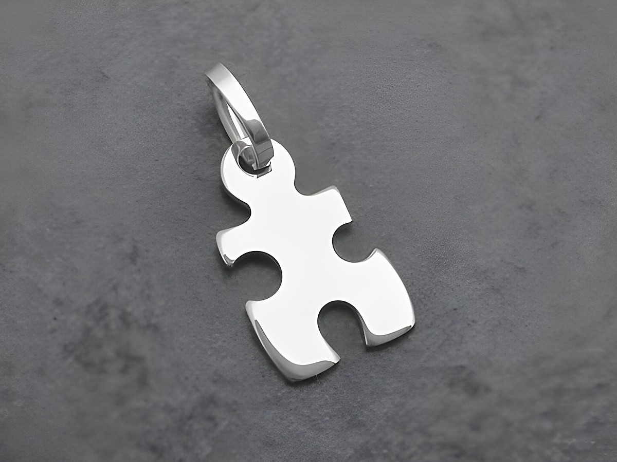 Puzzle Teil aus Sterling Silber als Anhänger, glänzende Oberfläche, von Juwelier Harnisch, ideal für Schmuckliebhaber und als bedeutungsvolles Geschenk.