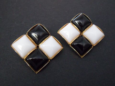 Ohrclip in schwarz-weiß mit zeitlosem Design, goldfarbener Umrandung und Kunstharzdetails, hergestellt von Juwelier Harnisch, ideal für elegante Anlässe.