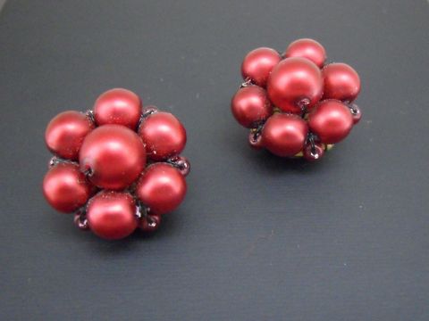 Dunkelrote, blumige Ohrclips mit goldfarbener Synthese-Zuchtperle in seidenmatter Optik, hergestellt von Juwelier Harnisch, stilvoll und elegant gestaltet.