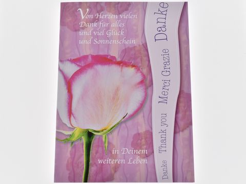 Dankeskarte mit rosa Rose und dem Schriftzug Danke in verschiedenen Sprachen. Hersteller Juwelier Harnisch. Gestaltung vermittelt Dankbarkeit und Wertschätzung.