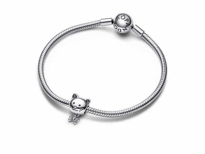 Ein schmaler Armband aus Sterling Silber mit einem charm in Form einer Katze und einer Schleife sowie klarem Zirkonia, hergestellt von Pandora.