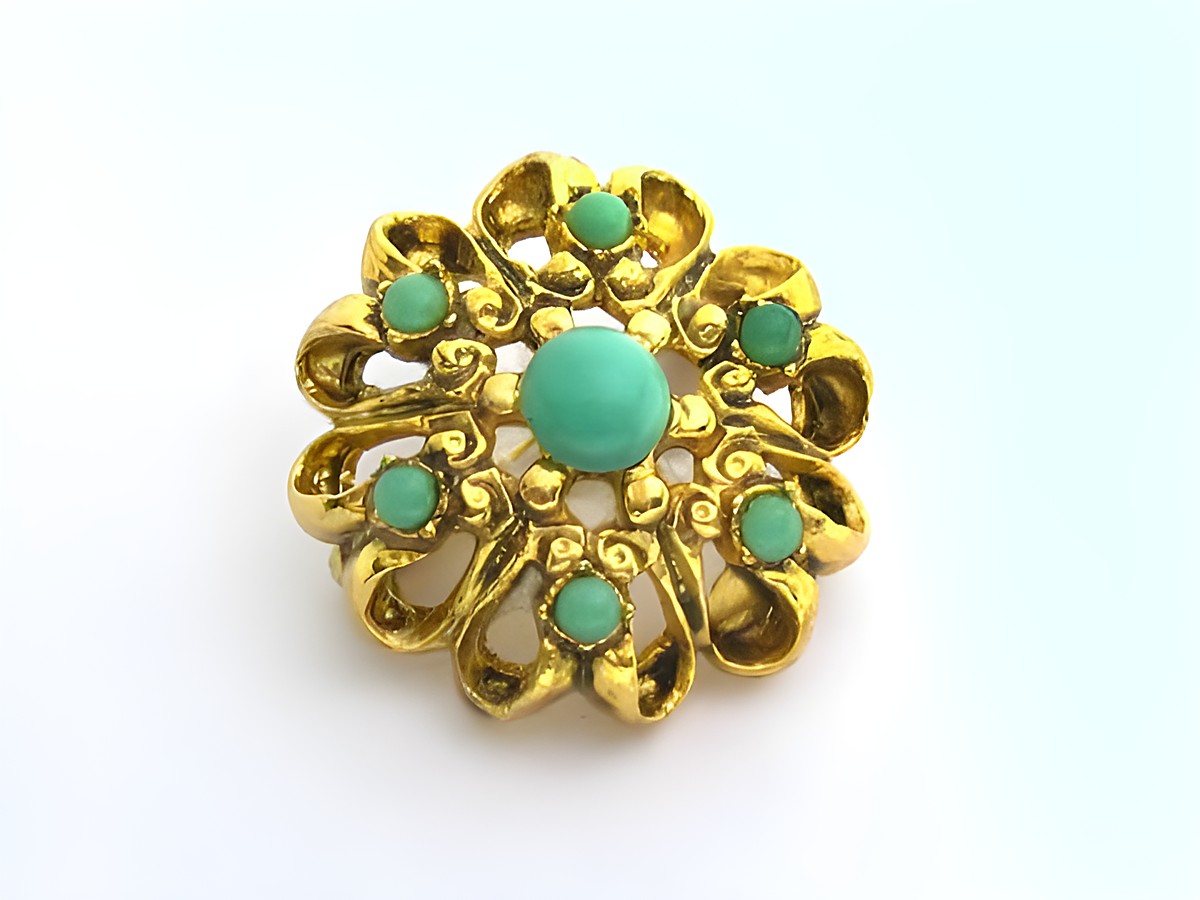 Brosche im Sexy City Look in rundem Design, türkis farbig mit goldfarbener Umrandung, Hersteller Juwelier Harnisch, ideal für elegante Akzente.