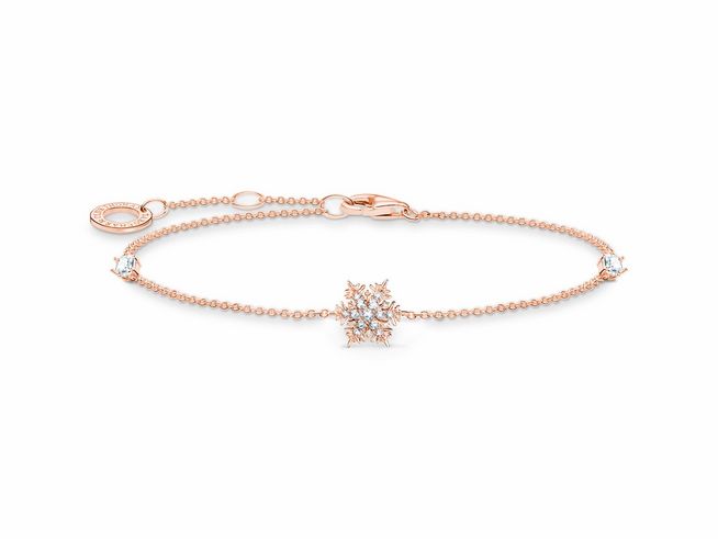Armband von Thomas Sabo aus Sterling Silber, vergoldet mit Roségold, verziert mit Zirkonia und einer Schneeflocke als Anhänger, elegant und funkelnd gestaltet.