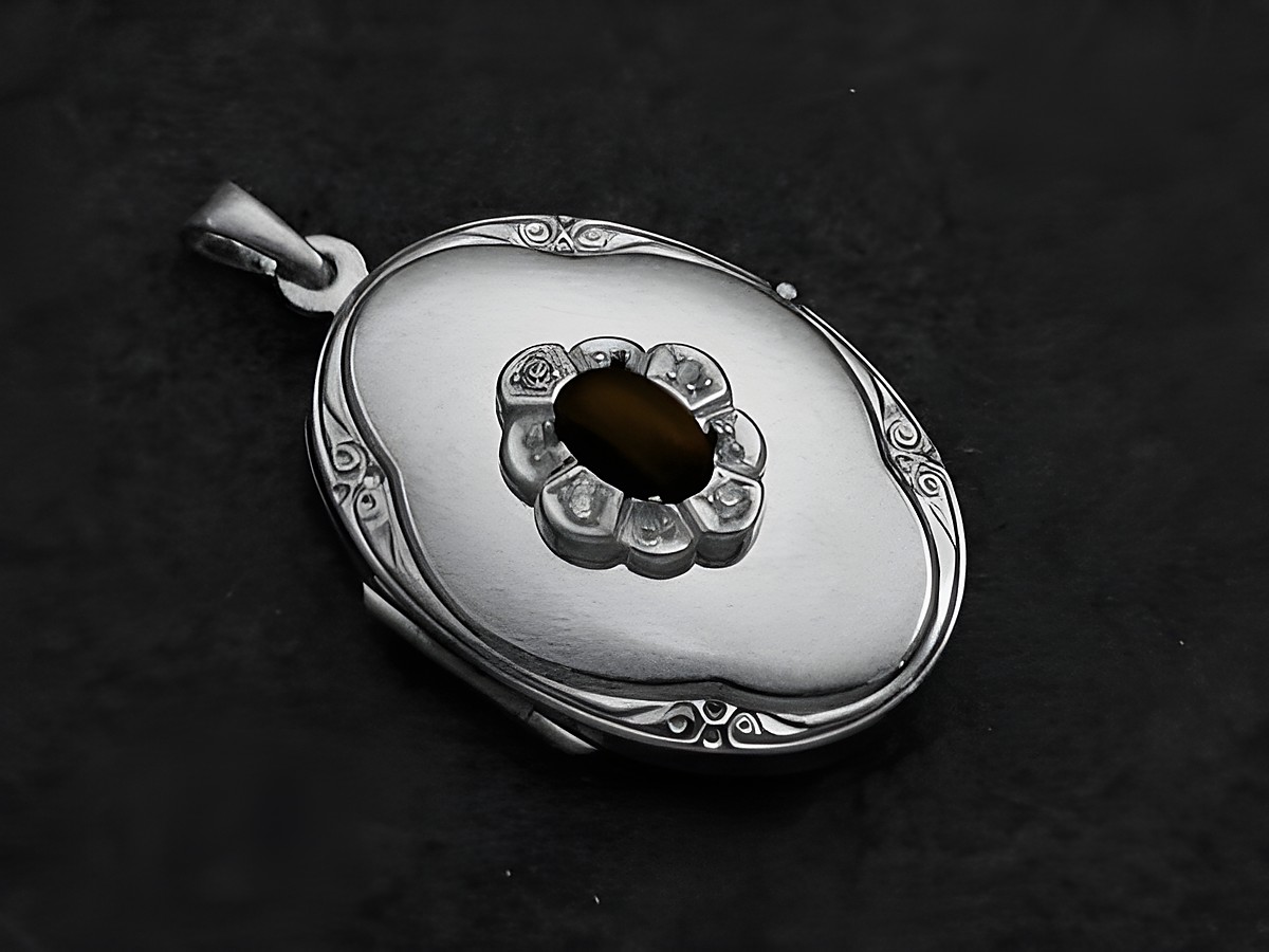Onyx schwarz Medaillon Cabochon aus Weißgold 585 von Juwelier Harnisch, filigran verarbeitet mit einem ovalen Design und einem dekorativen durchbrochenen Muster um den Stein.