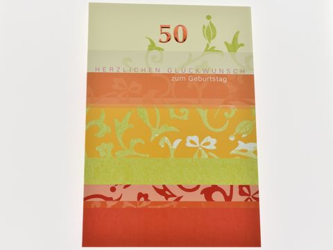 Geburtstagskarte mit Ornamenten in rötlich und grünlich, Hersteller Juwelier Harnisch, auf der Karte steht Herzlichen Glückwunsch zum Geburtstag und die Zahl 50.