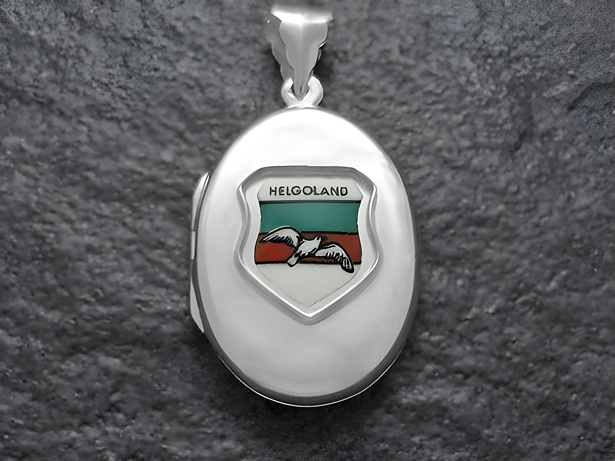 Silbermedaillon mit dem Wappen der Insel Helgoland, zeigt eine stilisierte Möwe auf buntem Hintergrund, gefertigt vom Juwelier Harnisch. Ideal als Schmuckstück zur Erinnerung.