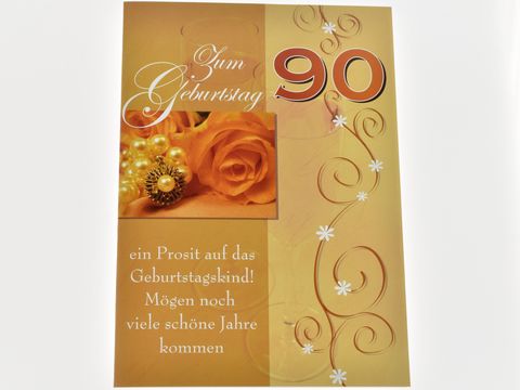 Eine elegante Geburtstagskarte in Goldtönen, geschmückt mit einer Rose und Perlen, mit der Aufschrift Zum Geburtstag 90 und dem Text ein Prosit auf das Geburtstagskind.