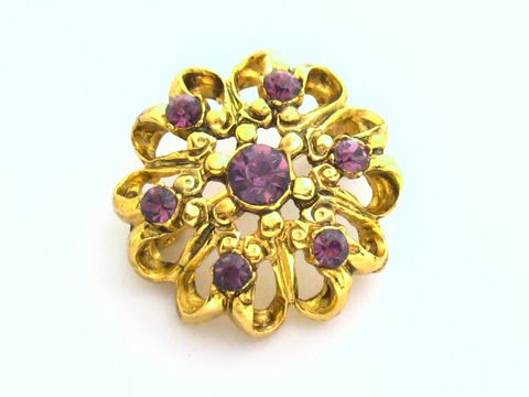 Lila Strass Brosche im Sexy City Look mit runden lila Strasssteinen und geschwungenem Golddesign, Hersteller Juwelier Harnisch. Ideal als elegantes Accessoire.