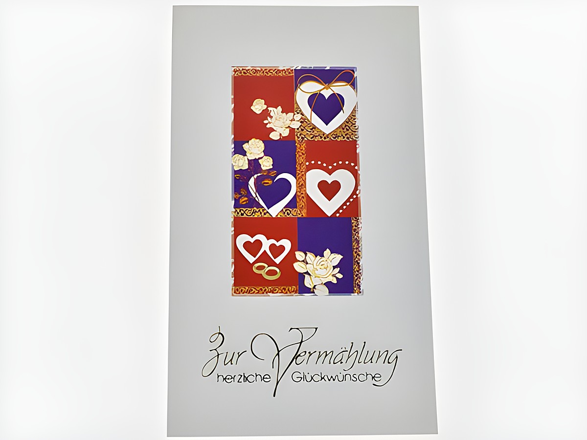 Hochzeitskarte mit verschiedenen Herzchen-Motiven in Rot, Blau und Weiß, verziert mit Blumen. Hersteller Juwelier Harnisch, ideal für Glückwünsche zur Vermählung.