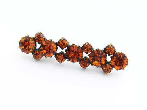Längliche Strass Brosche in Gelb und Braun, Hersteller Juwelier Harnisch, ideal für einen sexy City Look, funkelnde Steine in verschiedenen Größen verleihen einen eleganten Touch.