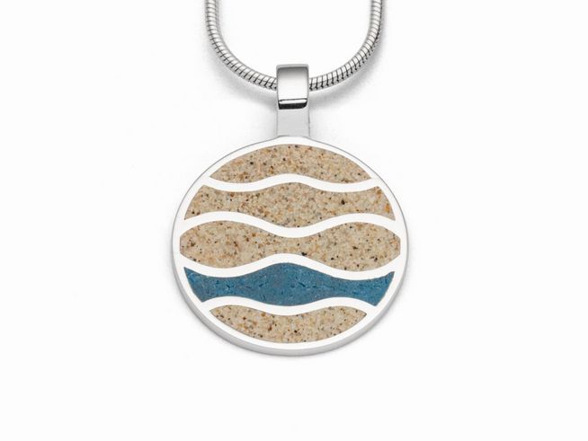 Sterling Silber Anhänger mit kreisförmigem Design, das Strandwellen darstellt. Die Wellen sind aus Strandsand und blauen Steinsand in verschiedenen Schattierungen gefertigt.