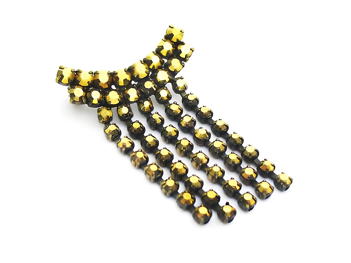 Goldige Strass Brosche im sexy City Look von Juwelier Harnisch. Die Brosche in Gelb und Braun verfügt über funkelnde Strasssteine und ein elegantes, auffälliges Design.