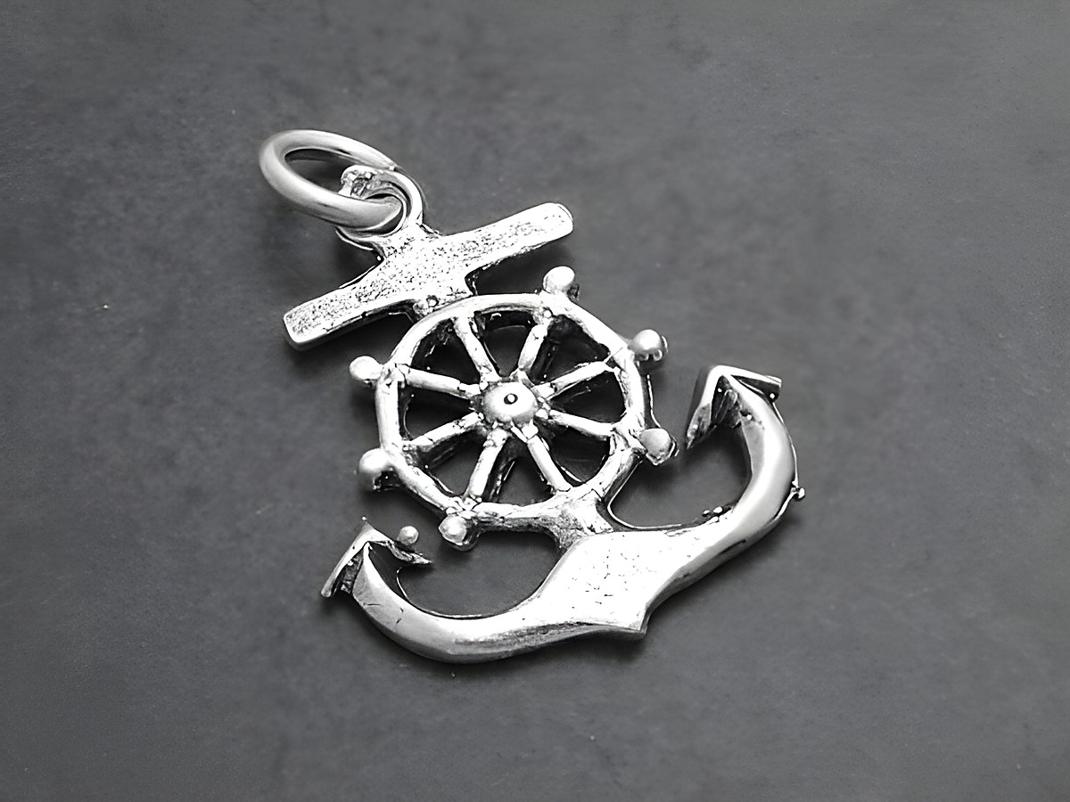 Ein Ruderanker aus 925 Sterling Silber mit einem Schiffsrad, elegant gestaltet und ideal für maritim inspirierte Schmuckstücke, hergestellt von Juwelier Harnisch.