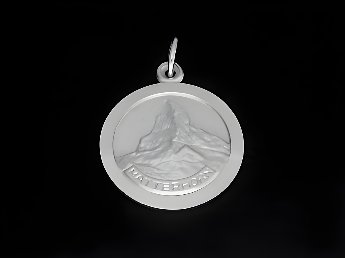 Matterhorn Anhänger aus Silber rhodiniert, rund mit eingeprägtem Matterhorn-Motiv. Hersteller Juwelier Harnisch, ideal als persönliches Schmuckstück oder Geschenk.