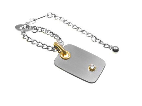 Edelstahl Schlüsselanhänger mit Zirkonia, teilvergoldet, von Juwelier Harnisch. Modernes Design mit glänzenden Akzenten und einer ansprechenden Form. Trocken und elegant.