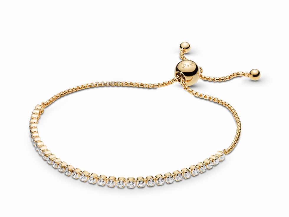 Das Bild zeigt ein Funkelarmband von Pandora mit goldener Färbung und zahlreichen Schmucksteinen, das eine verstellbare Schlaufe für individuelle Passform bietet.