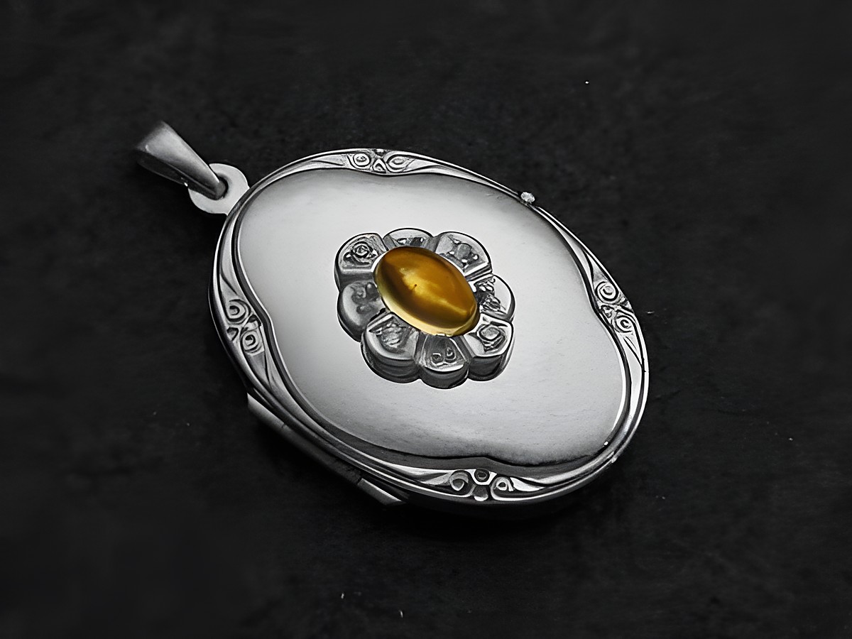Citrin gelber Medaillon Cabochon aus Weißgold 585, hergestellt von Juwelier Harnisch, mit filigraner Blütenverzierung und eleganter Form. Ideal als edles Schmuckstück.