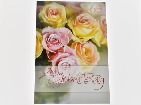 Eine Geburtstagskarte mit rosefarbenen Rosen und einer gelben Rose, dekoriert mit der Aufschrift zum Geburtstag, hergestellt von Juwelier Harnisch.
