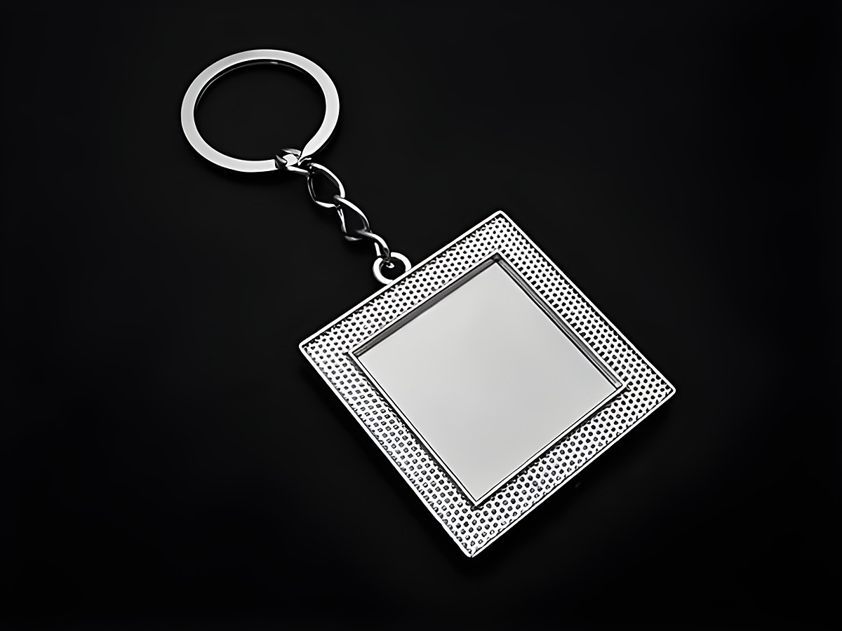 Silberfarbener Schlüsselanhänger in Form eines quadratischen Fotorahmens mit einer Länge von 10,5 cm, hergestellt von Juwelier Harnisch. Ideal zum persönlichen Gestalten.
