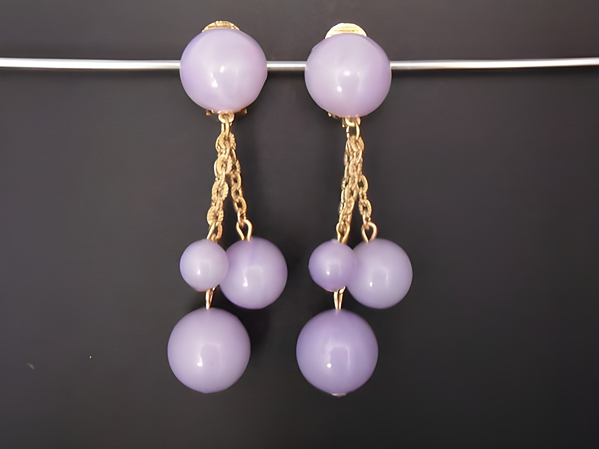Ohrclip in flieder zeitlos mit goldfarbenen Elementen und Kunstharz, Hersteller Juwelier Harnisch, elegant gestaltete Ohrringe mit verschiedenen Längen und Farbnuancen.