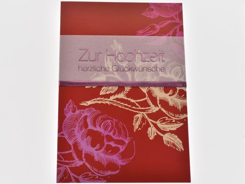 Rote Hochzeitskarte mit floralen Elementen und einem farblich abgesetzten Aufdruck, Hersteller Juwelier Harnisch, geeignet für herzliche Glückwünsche zur Hochzeit.