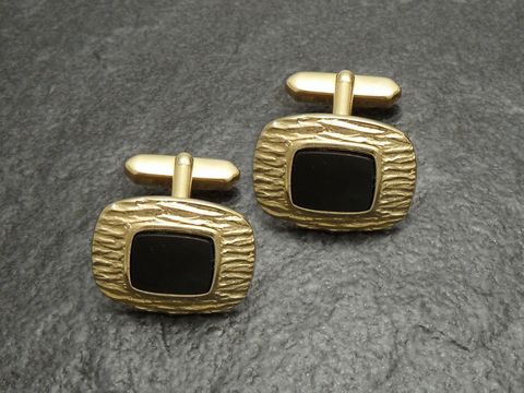 Manschettenknöpfe vergoldet in elegantem Schwarz Onyx-Look, Hersteller Juwelier Harnisch, goldfarbenes Design mit strukturierter Oberfläche und schwarzen Einsätzen.